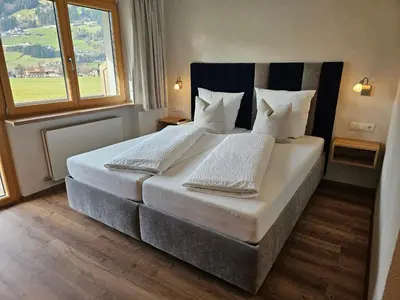 Ein Bett oder Betten in einem Zimmer der Unterkunft Alpenzeit Zillertal Apartments