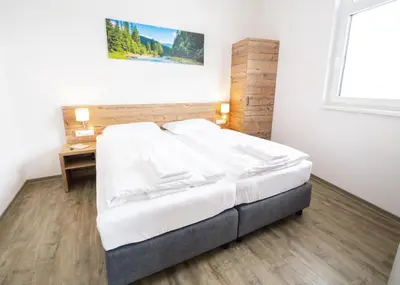 Ein Bett oder Betten in einem Zimmer der Unterkunft Alpenstyle Resort Fieberbrunn by AlpenTravel
