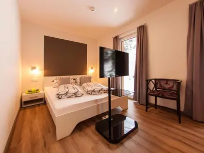 Ein Bett oder Betten in einem Zimmer der Unterkunft LoriVita Residenz Saalbach
