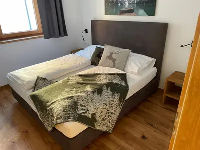 Ein Bett oder Betten in einem Zimmer der Unterkunft Chalet Buchensteinwand Luxusapartment mit Sauna am Berg