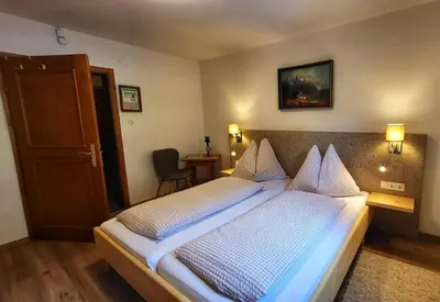 Ein Bett oder Betten in einem Zimmer der Unterkunft Berghotel Breitmoos