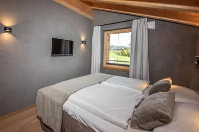 Ein Bett oder Betten in einem Zimmer der Unterkunft Filzsteinresort Wohnungen Top 11