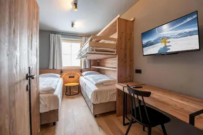 Ein Bett oder Betten in einem Zimmer der Unterkunft Filzsteinresort Wohnungen Top 6