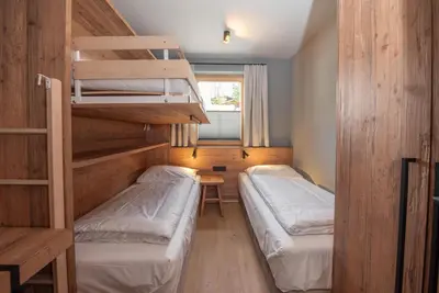 Ein Bett oder Betten in einem Zimmer der Unterkunft Filzsteinresort Wohnungen Top 8
