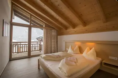 Ein Bett oder Betten in einem Zimmer der Unterkunft Schöneben Haus Alpenglöckchen