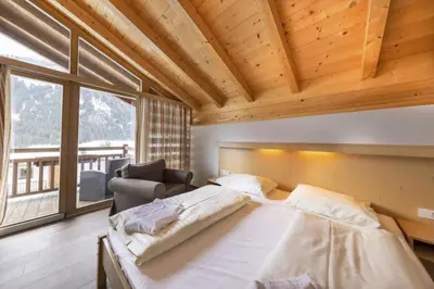 Ein Bett oder Betten in einem Zimmer der Unterkunft Schöneben Haus Anemone