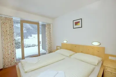 Ein Bett oder Betten in einem Zimmer der Unterkunft Schöneben Haus Sonneck