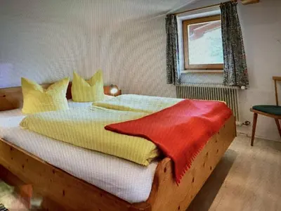 Ein Bett oder Betten in einem Zimmer der Unterkunft Appartement Foidl mit Kaiser & Hornblick
