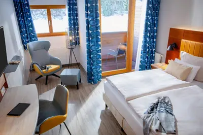 Ein Bett oder Betten in einem Zimmer der Unterkunft ROBINSON Fieberbrunn - Adults only