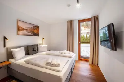 Ein Bett oder Betten in einem Zimmer der Unterkunft Modern garden apartment with sauna near ski lift