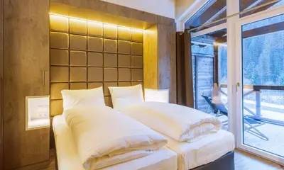 Ein Bett oder Betten in einem Zimmer der Unterkunft AvenidA Mountain Lodges Saalbach