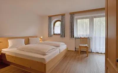 Ein Bett oder Betten in einem Zimmer der Unterkunft Gasthof Appartement`s Staffnerhof