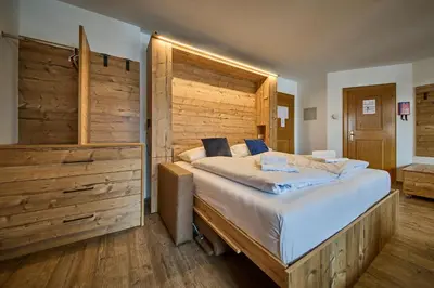 Ein Bett oder Betten in einem Zimmer der Unterkunft Delfi Ski & Bike Apartments