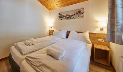 Ein Bett oder Betten in einem Zimmer der Unterkunft Delfi Ski & Bike Apartments