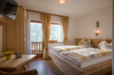 Ein Bett oder Betten in einem Zimmer der Unterkunft Gästehaus Rahm - Familie Wechselberger