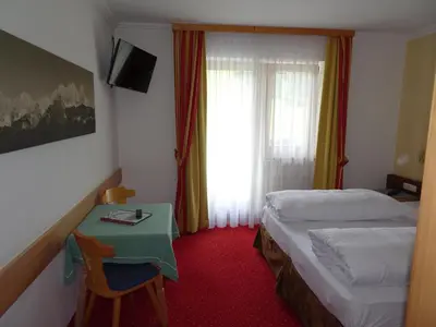 Ein Bett oder Betten in einem Zimmer der Unterkunft Alpenhotel Landhaus Küchl