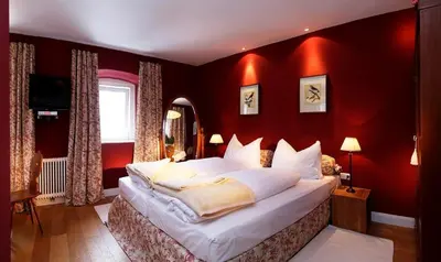 Ein Bett oder Betten in einem Zimmer der Unterkunft Hotel Gasthof Post Nostalgie & Wohlfühlen
