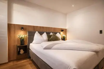 Ein Bett oder Betten in einem Zimmer der Unterkunft BLACKSYTLE - by AlpenLuxus Collection