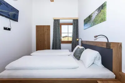 Ein Bett oder Betten in einem Zimmer der Unterkunft Ferienwohnungen Hausbacher-Bichlhof