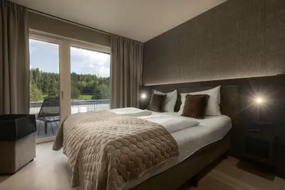 Ein Bett oder Betten in einem Zimmer der Unterkunft Berg & Golf Apartments Westendorf by ALPS RESORTS
