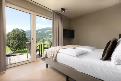 Ein Bett oder Betten in einem Zimmer der Unterkunft Berg & Golf Apartments Westendorf by ALPS RESORTS