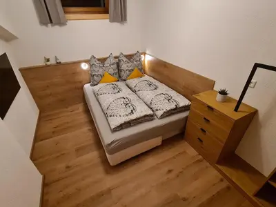 Ein Bett oder Betten in einem Zimmer der Unterkunft Landhaus KitzAlp (Alpenheim)