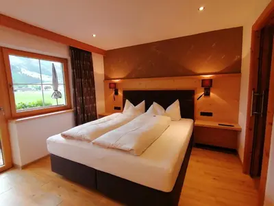 Ein Bett oder Betten in einem Zimmer der Unterkunft Tirol Appartement Haus Zillertal