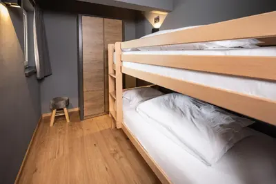 Ein Bett oder Betten in einem Zimmer der Unterkunft Schöneben Appartementen Big Family