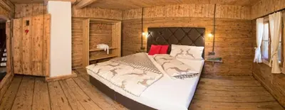 Ein Bett oder Betten in einem Zimmer der Unterkunft Bergchalet Heidialm