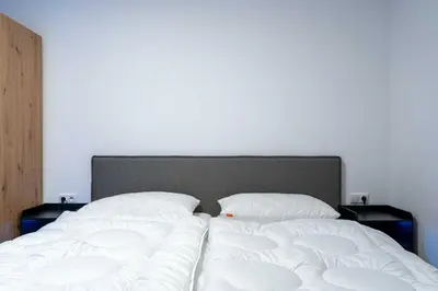 Ein Bett oder Betten in einem Zimmer der Unterkunft Alpenglück Apartments by we rent, JOKERCARD INCLUDED