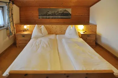 Ein Bett oder Betten in einem Zimmer der Unterkunft Hotel Kitzbühler Alpen