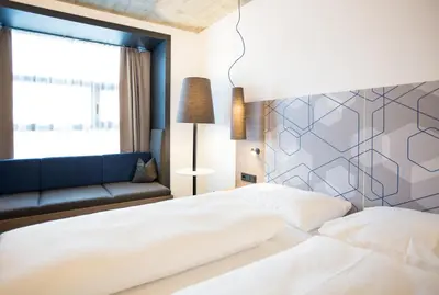Ein Bett oder Betten in einem Zimmer der Unterkunft arte Hotel Kufstein