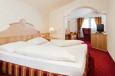 Ein Bett oder Betten in einem Zimmer der Unterkunft Hotel Jenbacherhof B&B