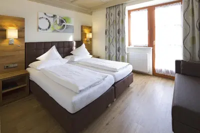 Ein Bett oder Betten in einem Zimmer der Unterkunft Hotel Gasthof Obermair