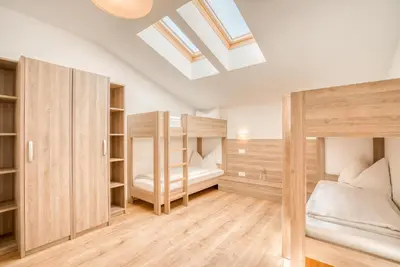 Ein Bett oder Betten in einem Zimmer der Unterkunft COOEE alpin Hotel Kitzbüheler Alpen