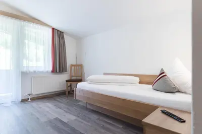 Ein Bett oder Betten in einem Zimmer der Unterkunft Gasthof Venedigerblick
