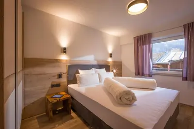 Ein Bett oder Betten in einem Zimmer der Unterkunft Aparthotel AlpTirol