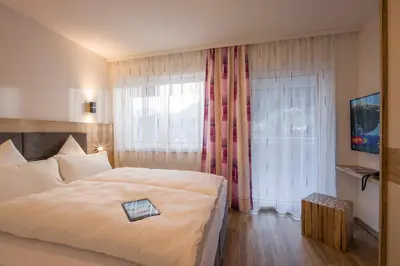 Ein Bett oder Betten in einem Zimmer der Unterkunft Aparthotel AlpTirol