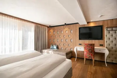 Ein Bett oder Betten in einem Zimmer der Unterkunft SonnenHOF hotel gerlos centrum