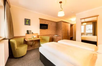 Ein Bett oder Betten in einem Zimmer der Unterkunft Hotel Garni Entstrasser