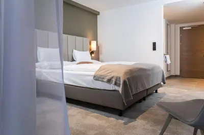 Ein Bett oder Betten in einem Zimmer der Unterkunft Das Hohe Salve Sportresort, 4 Sterne Superior