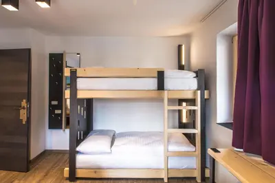 Ein Bett oder Betten in einem Zimmer der Unterkunft Blackriver Lodge Saalbach - inkl CrossFit Gym