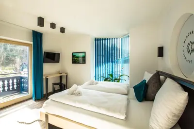 Ein Bett oder Betten in einem Zimmer der Unterkunft Blackriver Lodge Saalbach - inkl CrossFit Gym