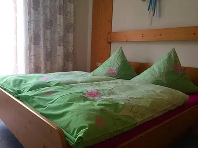 Ein Bett oder Betten in einem Zimmer der Unterkunft Ferienwohnungen Luxner