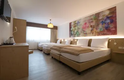 Ein Bett oder Betten in einem Zimmer der Unterkunft Family Hotel Schloss Rosenegg