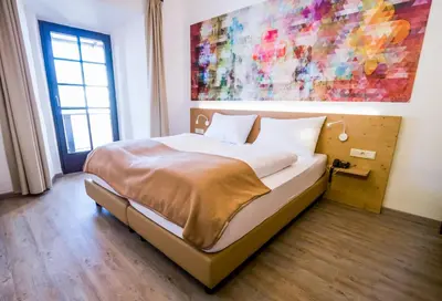 Ein Bett oder Betten in einem Zimmer der Unterkunft Family Hotel Schloss Rosenegg