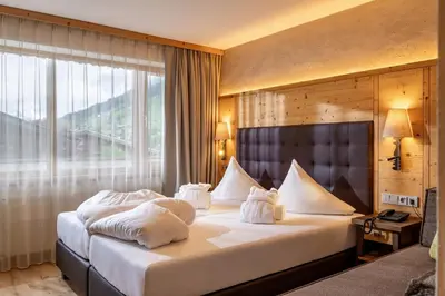Ein Bett oder Betten in einem Zimmer der Unterkunft Alpen Glück Hotel Kirchberger Hof