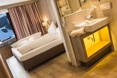 Ein Bett oder Betten in einem Zimmer der Unterkunft Hotel am Reiterkogel