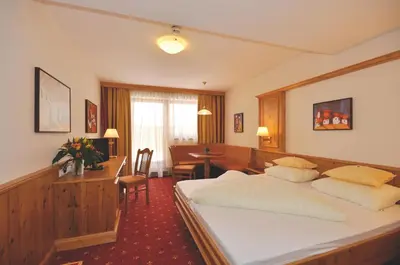 Ein Bett oder Betten in einem Zimmer der Unterkunft Hotel Alphof Alpbach