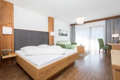 Ein Bett oder Betten in einem Zimmer der Unterkunft Hotel Alphof Alpbach